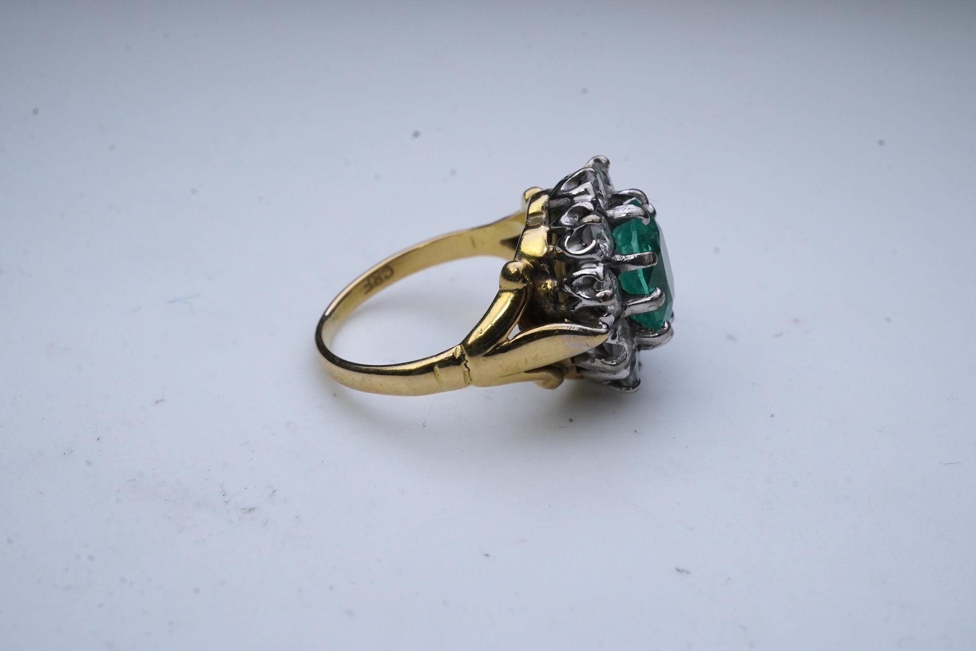 An emerald and diamond ring